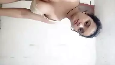 Young girl in bathroom, removing suit